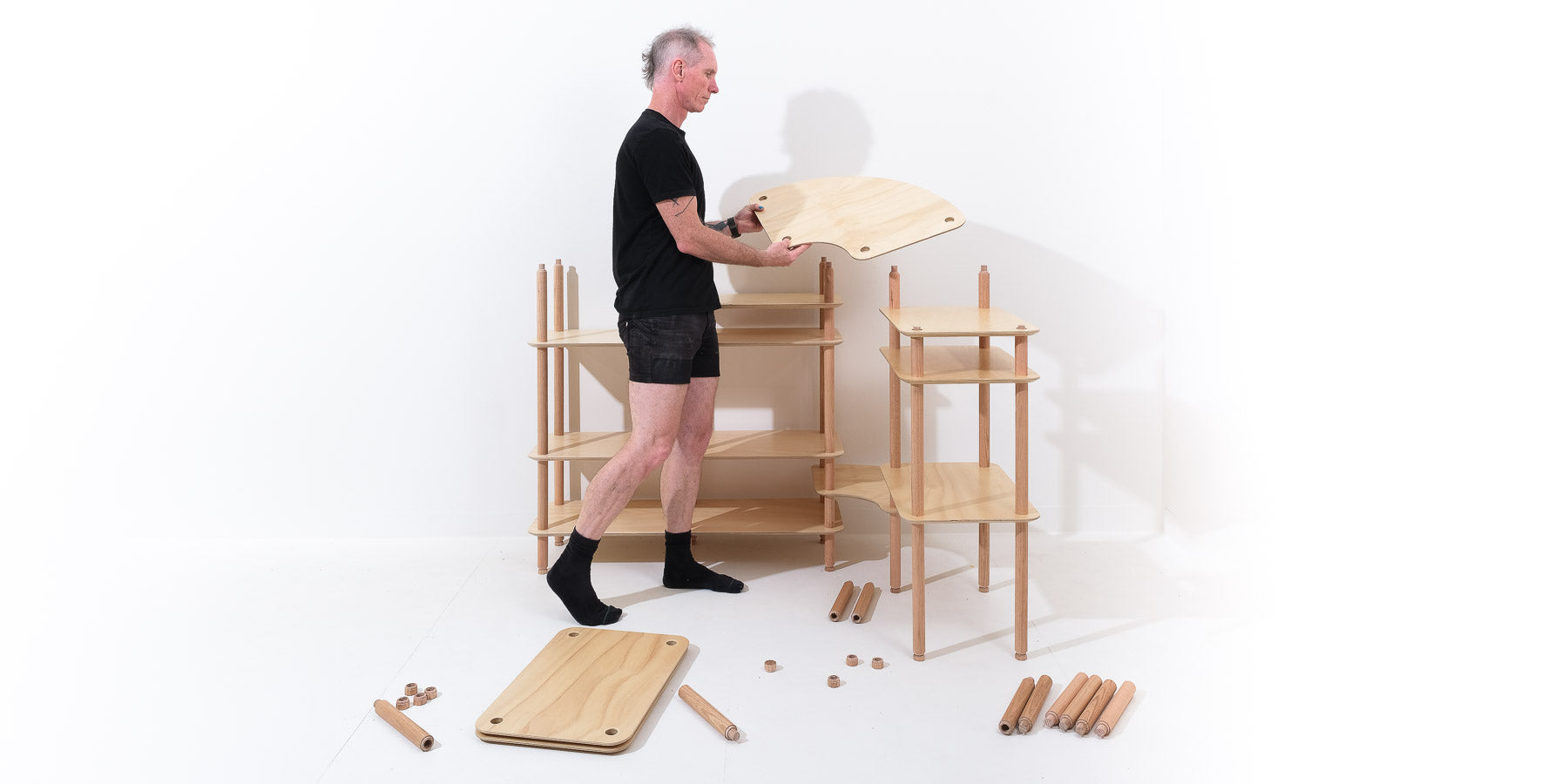 Team member Kent assembling a custom KittaParts shelving system